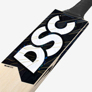 DSC Blak 111 cricket bat close-up showing the model label, black DSC branding and upper blade