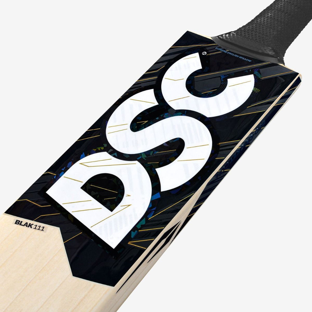 DSC Blak 111 cricket bat close-up showing the model label, black DSC branding and upper blade